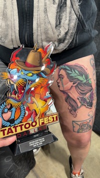 a tattoo of an astronaut on a thigh